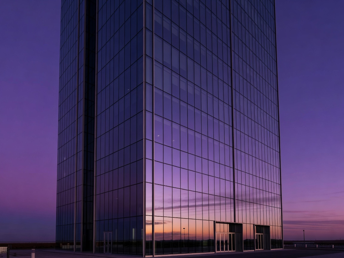 Architectural glass skyscraper reflecting royal purple sky at dusk